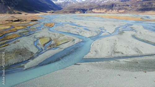 Icelandic river and waterfall with mountains on the background drone show in 4K