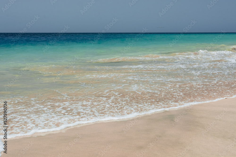 Summer beach, ocean waves on a tropical sea with deep blue wawes.