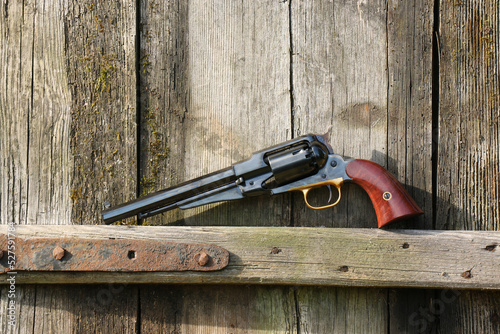 Black powder revolver on an old board