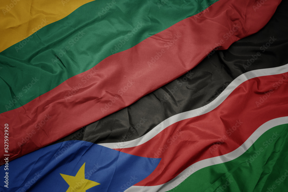 waving colorful flag of south sudan and national flag of lithuania. waving colorful flag of south sudan and national flag of lithuania.