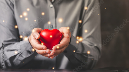 Empathy female manager holding human icon with heart shape over palm hands. Power of emotional intelligent, soft skill development concept