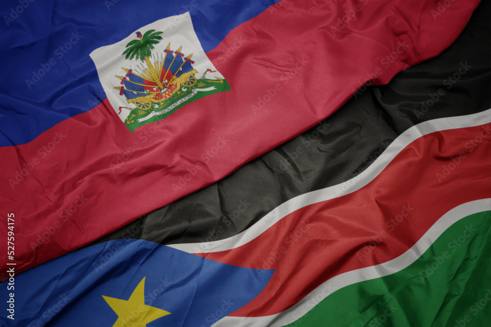 Fototapeta premium waving colorful flag of south sudan and national flag of haiti.