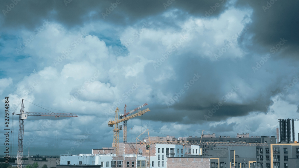 Construction cranes in the clouds