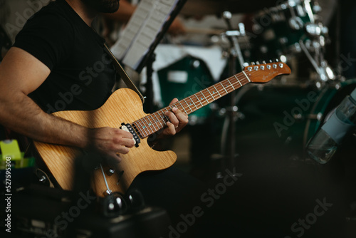 Close up musician playing electric guitar