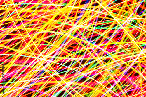 Chaos texture. Neon lights background. Motion lines texture. Long exposure moving light pattern. Abstract night life background. Glowing lines design. Colorful illumination.