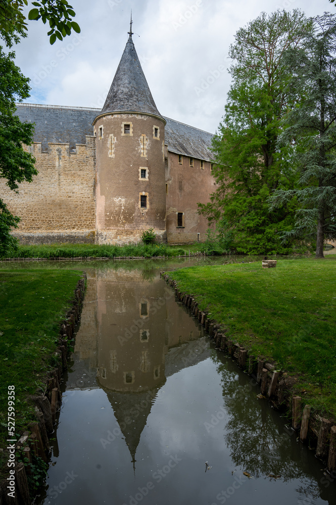 Castle of Ainay-le-Vieil reflected in her moat