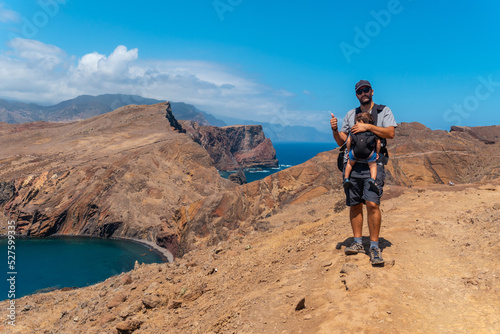 Wallpaper Mural A father with his baby in summer in Ponta de Sao Lourenco looking at the landscape and the sea, coast of Madeira Torontodigital.ca
