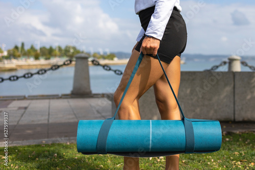 Yoga mat in the hands of a girl