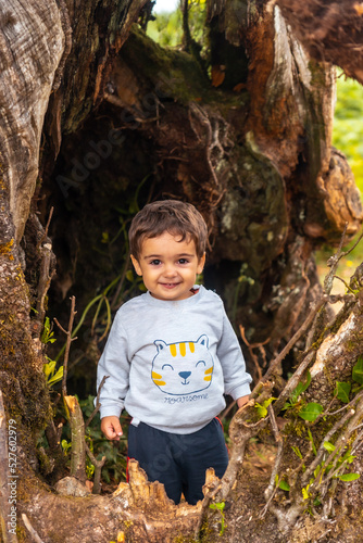 Fanal forest in Madeira, baby portrait in the cave of a laurel tree exploring the interior