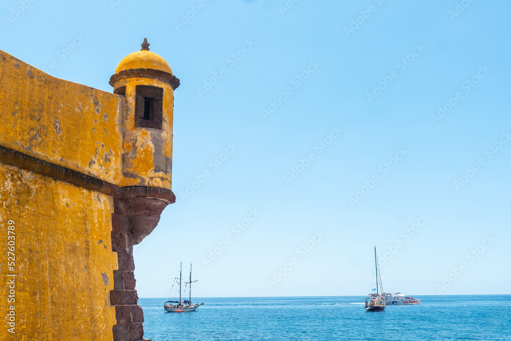 Yellow watchtower at the Forte de Sao Tiago on the beach of Funchal. Madeira