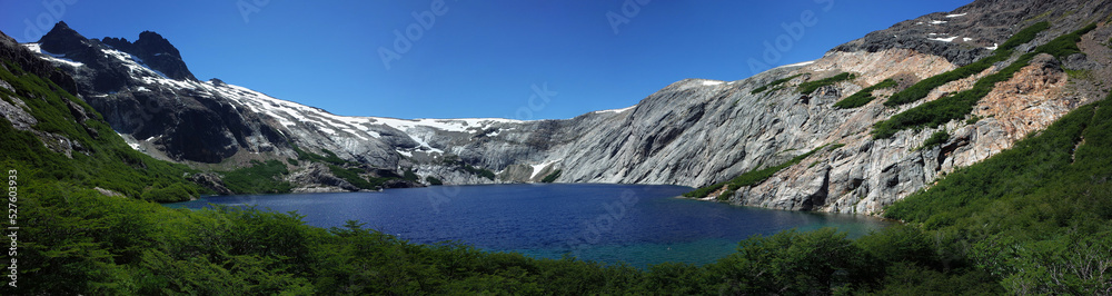 Alpine blue lake panorama, Laguna Azul in Nahuel Huapi National Park, granite walls of Cerro de las Cristales mountain, Argentina, Nature of Patagonia