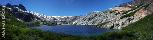 Alpine blue lake panorama, Laguna Azul in Nahuel Huapi National Park, granite walls of Cerro de las Cristales mountain, Argentina, Nature of Patagonia