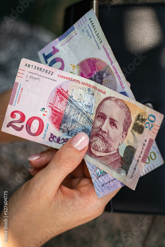 Hands holding georgian lari bills. Bunch of banknotes of Georgia money