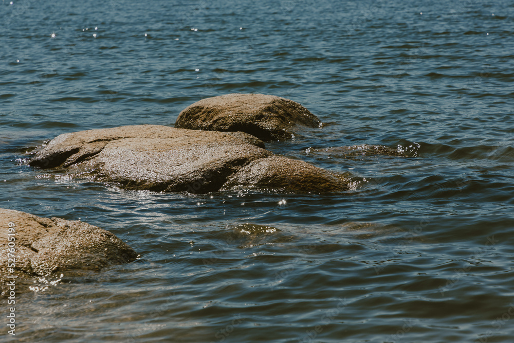 Fototapeta premium A close-up of large stones in the water.