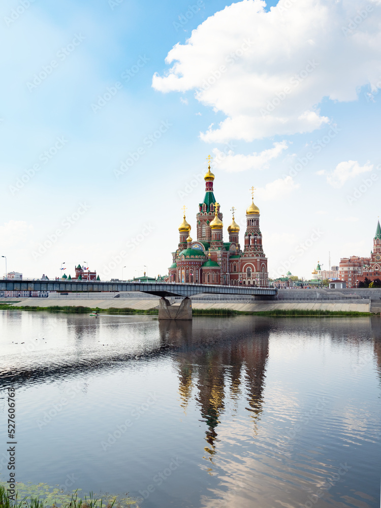 view of Theater bridge across Malaya Kokshaga river and Cathedral of the Annunciation of the Blessed Virgin Mary in Yoshkar-ola city on summer day
