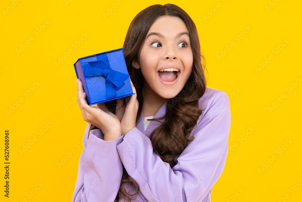 Teenager child with gift box. Present for holidays. Happy birthday, Valentines day, New Year or Christmas. Kid hold present box. Happy teenage girl, positive and smiling emotions. Teenager child with gift box. Present for holidays. Happy birthday, Valentines day, New Year or Christmas. Kid hold present box. Happy teenage girl, positive and smiling emotions.
