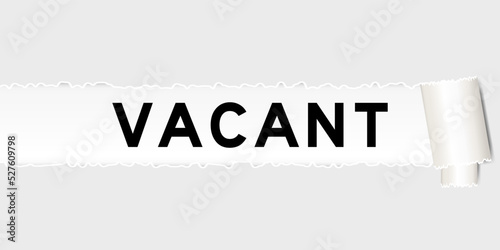 Ripped gray paper background that have word vacant under torn part