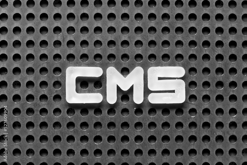 White alphabet letter in word CMS (Abbreviation of Content management system) on black pegboard background White alphabet letter in word CMS (Abbreviation of Content management system) on black pegboard background