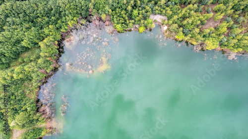 Blue lakes from above. Lakes in green forest in evening sunlight aerial drone view. Scenic summer background. Picturesque lakeside with forest. High quality photo. High quality photo