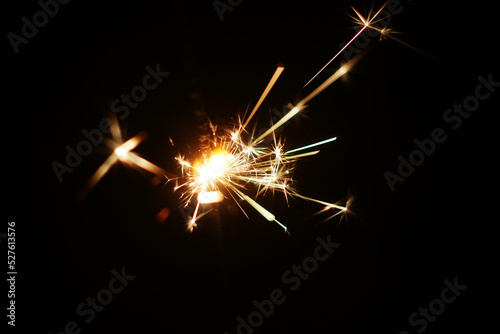 Bengal sparkler in the dark. Festive glowing element