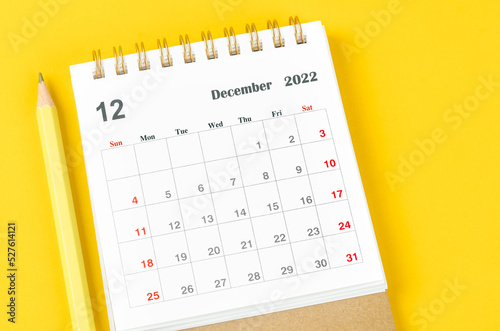 The December 2022 Monthly desk calendar for 2022 year on Yellow background.