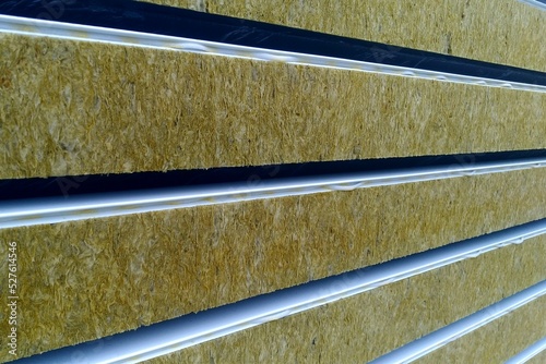 Sandwich panels with mineral wool filling, side view, a stack of panels prepared for installation.