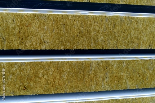 Sandwich panels with mineral wool filling, side view, a stack of panels prepared for installation.