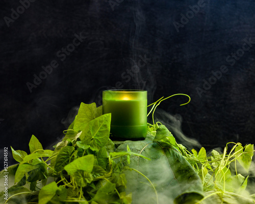 Photography object photo of a candle on a black background, the candle stands on a variety o