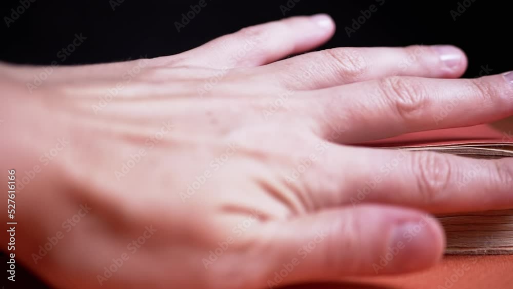 Girl Touching Pages of an Old, Ancient, Antique, Thick Red Book with Fingers. Mysterious, mystical atmosphere. Black, orange background. Library. Archive. Manuscript. Reading knowledge Midnight. Girl Touching Pages of an Old, Ancient, Antique, Thick Red Book with Fingers. Mysterious, mystical atmosphere. Black, orange background. Library. Archive. Manuscript. Reading knowledge Midnight.
