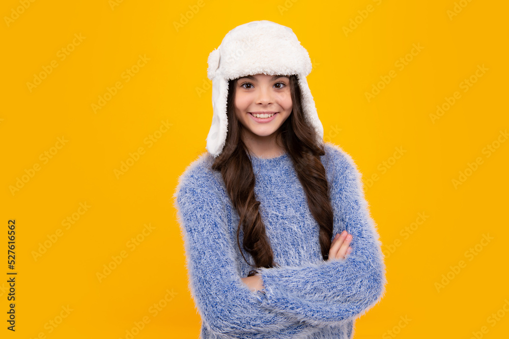 Winter hat. Cold season concept. Winter fashion accessory for children. Teen girl wearing warm knitted hat. Happy teenager, positive and smiling emotions of teen girl.