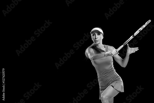 Young athletic woman playing tennis and hitting ball with racket © Denys Kurbatov