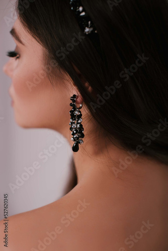 Woman with jewelry on her hair. Beautiful woman with professional makeup.