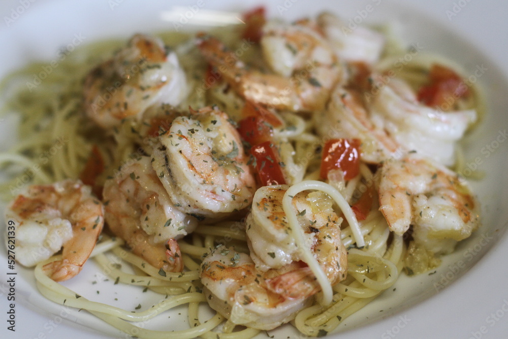 Spaghetti alla olio with shrimp in white shallow bowl Spaghetti alla olio with shrimp in white shallow bowl