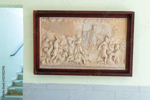 HAIFA, ISRAEL. June 26, 2022: Muhraka monastery of the Carmelite on the Carmel mount . Bas-relief depicting the priests of Baal at the altar and prophet Elijah photo