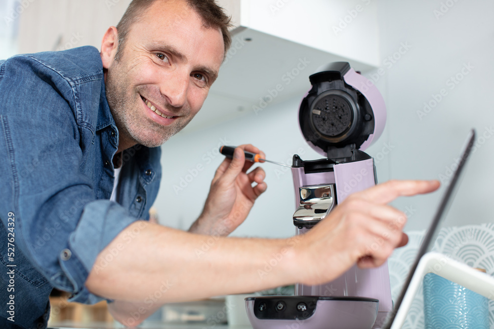 man is fixing coffee machine man is fixing coffee machine