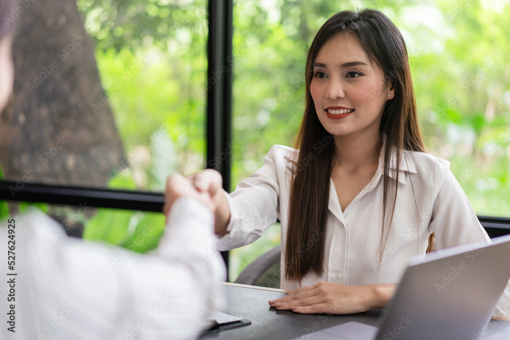 Coworker business concept, Two businesswoman shake hands after successfully discussing the project Coworker business concept, Two businesswoman shake hands after successfully discussing the project