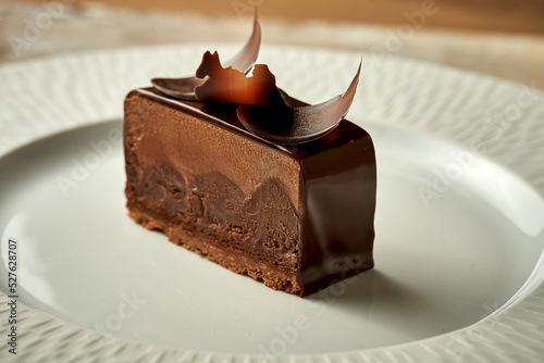 Chocolate mousse cake with frosting. Noise added in post-production. Selective focus