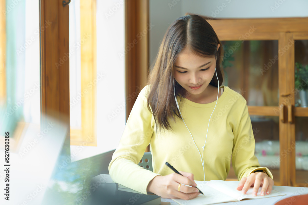 Education and literacy concept, College student girl use phone to listening lecture and taking note Education and literacy concept, College student girl use phone to listening lecture and taking note