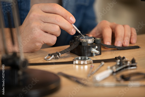 Tableau sur toile close cropped view of wrist watch being repaired
