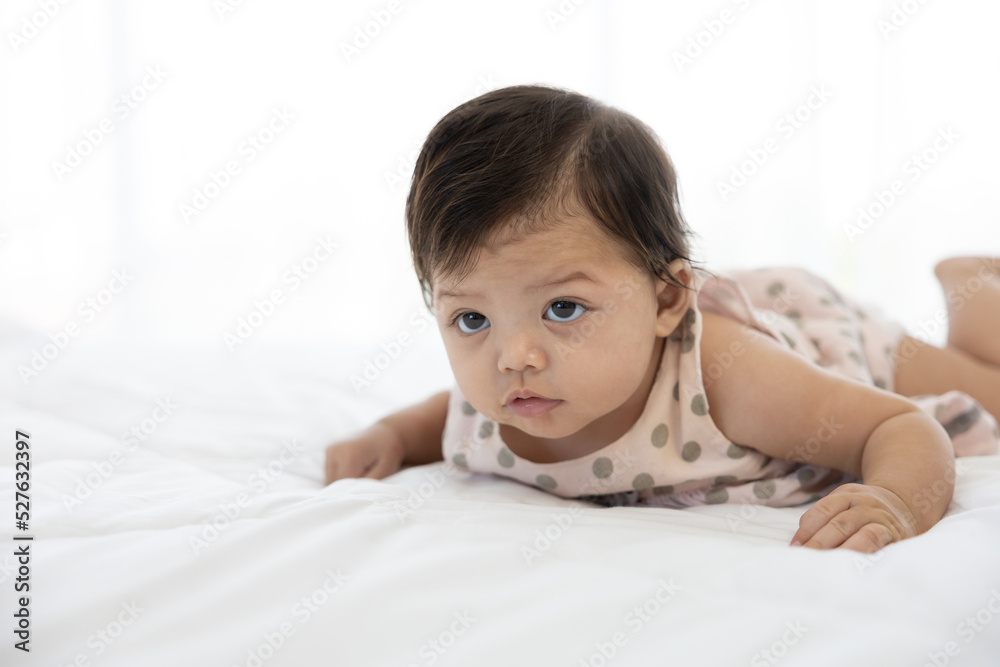 portrait cute baby crawling on bed and looking to something portrait cute baby crawling on bed and looking to something