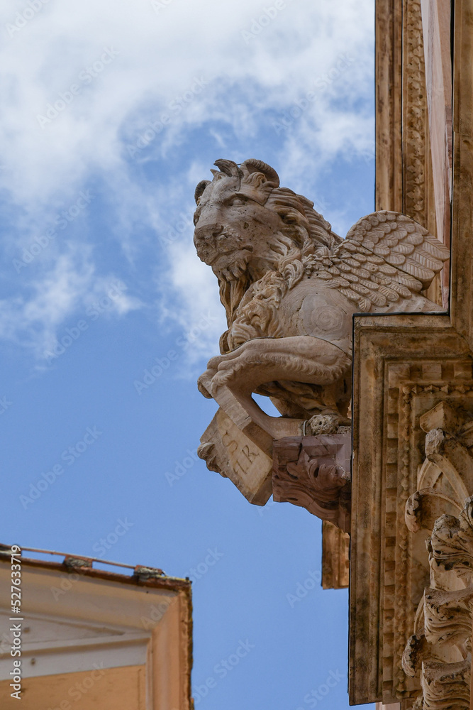 Statue of the winged lion, symbolic representation of the Evangelist Mark, on the façade of the medieval Grosseto Cathedral, Tuscany, Italy