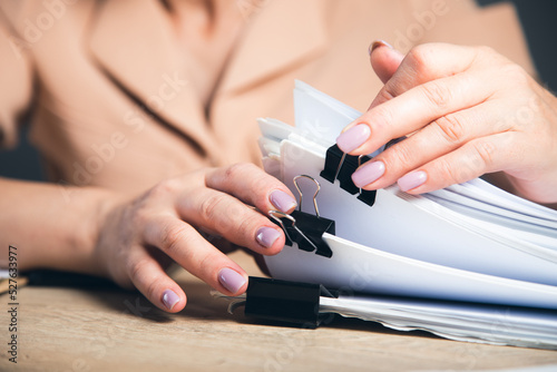 woman hand stack of report papers documen photo