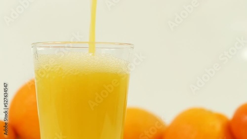 This refreshing stock photo showcases juicy oranges and freshly squeezed juice on a clean white background, perfect for health, wellness, and food-related content.
