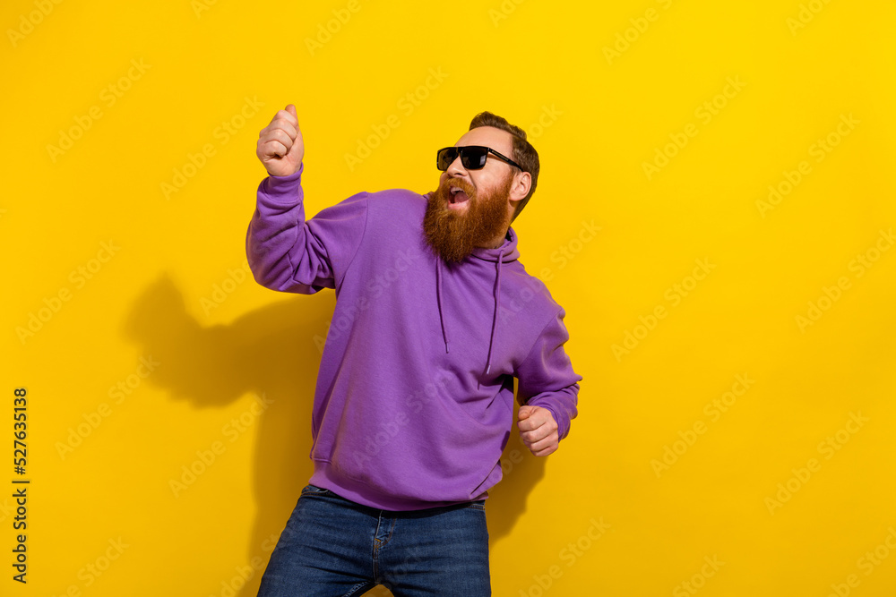 Photo of pretty handsome guy dressed purple sweater dark eyewear dancing isolated yellow color background Photo of pretty handsome guy dressed purple sweater dark eyewear dancing isolated yellow color background