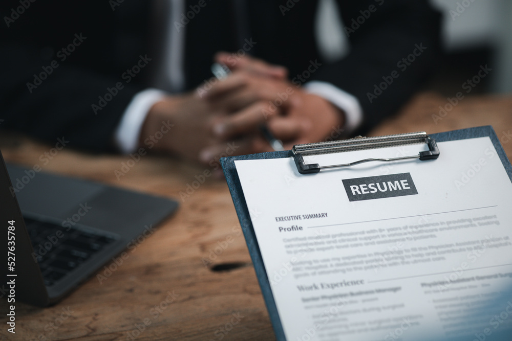 Person submitting resume to interview for a job with a company, Person attending a job interview with a manager to be recruited to the company for the position applied for. Job application concept. Person submitting resume to interview for a job with a company, Person attending a job interview with a manager to be recruited to the company for the position applied for. Job application concept.