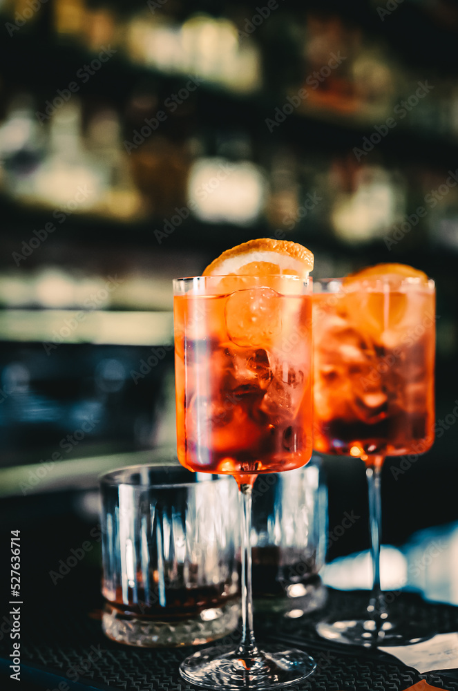 Aperol Spritz Cocktail in glass on bar counter Aperol Spritz Cocktail in glass on bar counter