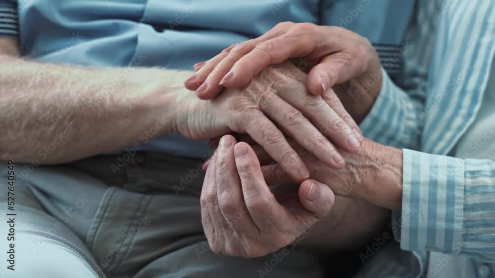 Senior couple, Taking care of the disabled partner. Concept about third age and real love and care. Close up on hands holding together. Senior couple, Taking care of the disabled partner. Concept about third age and real love and care. Close up on hands holding together.