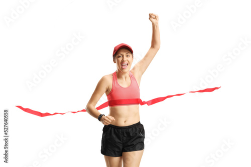 Happy young woman on the finish line of a race