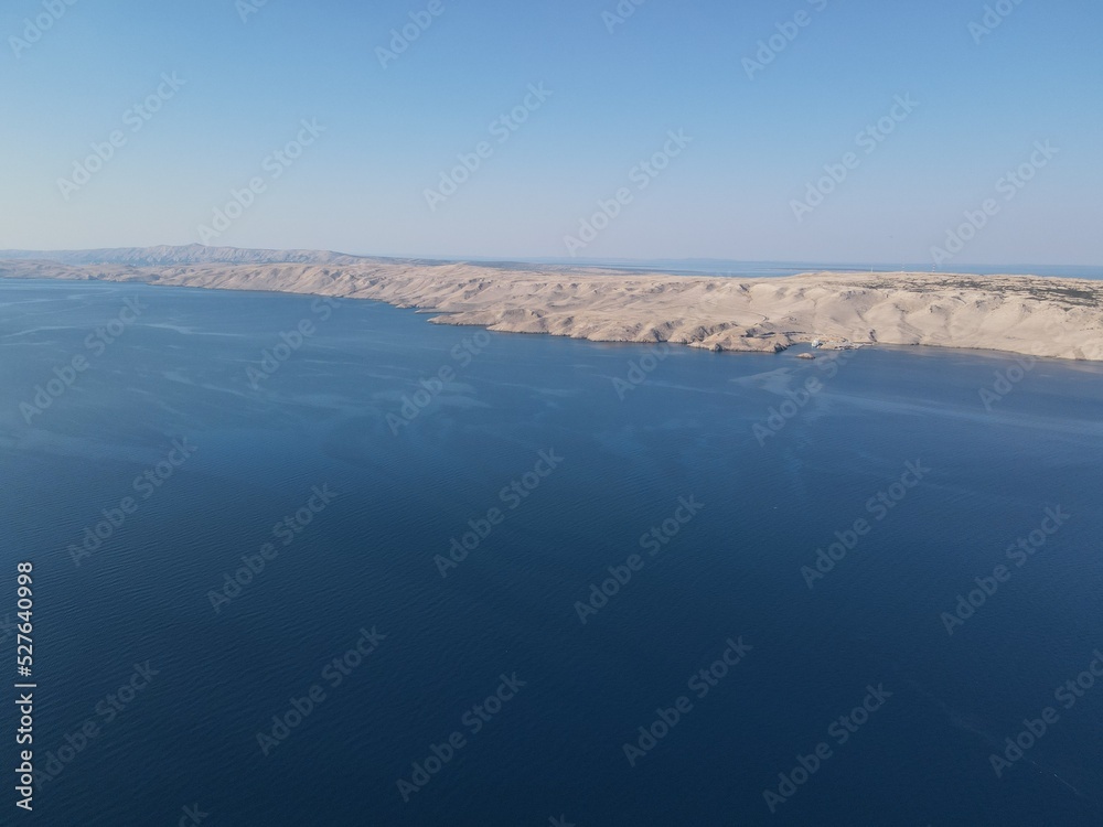 Aerial view of Prizna, Trajekt Prizna-Zigljen to reach the island of Pag. Drone view of queue to catch ferry for Pag. Small town with turquoise water on the hill of Croatia, in Dalmatia.