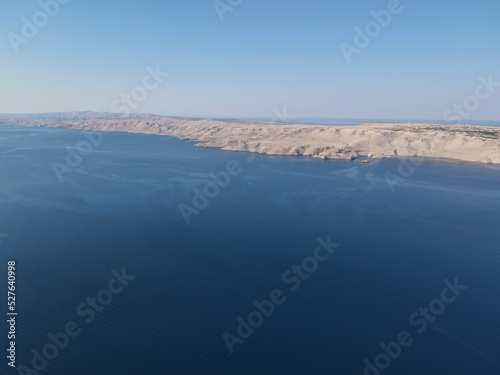 Aerial view of Prizna  Trajekt Prizna-Zigljen to reach the island of Pag. Drone view of queue to catch ferry for Pag. Small town with turquoise water on the hill of Croatia  in Dalmatia.